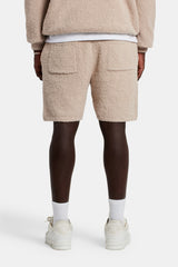 Male model wearing the textured knitted short in beige