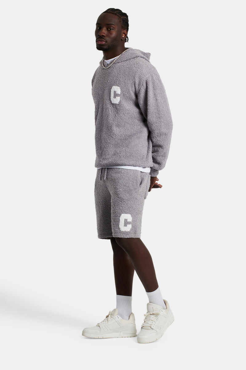 Male model wearing the Textured Knitted Hooded Short Tracksuit in grey