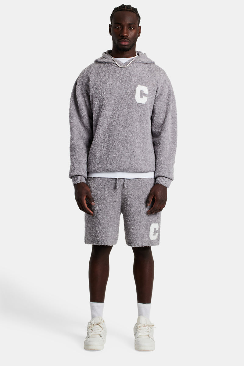 Male model wearing the Textured Knitted Hooded Short Tracksuit in grey