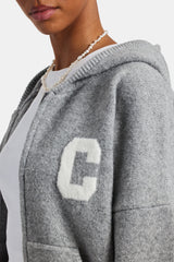 female model wearing the hooded zip through knitted jumper in grey