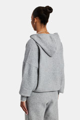 female model wearing the hodded zip through knitted tracksuit in grey