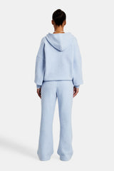 Female Model wearing hooded zip through knitted tracksuit in light blue