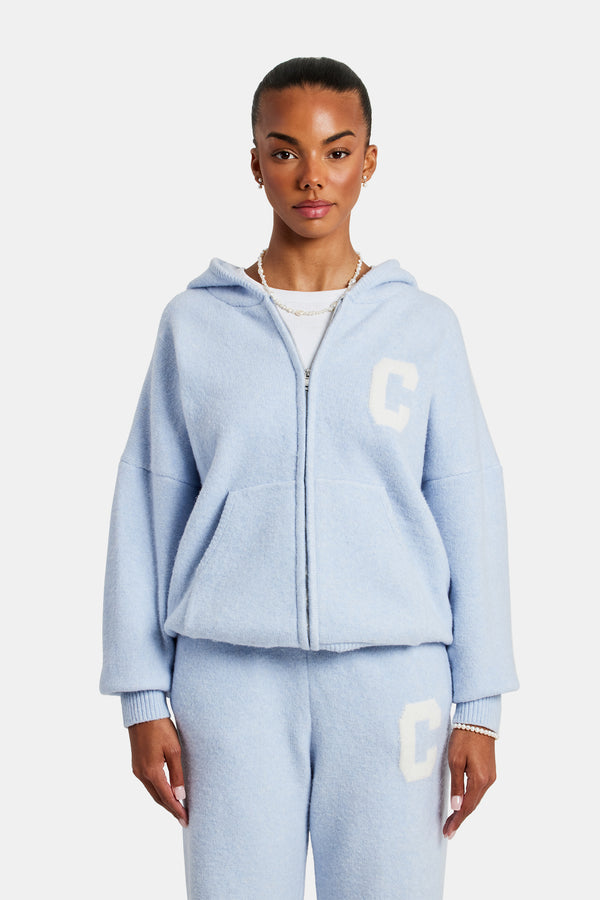 female model wearing the hooded zip through knitted jumper in light blue